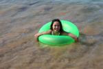 Jax wave rides in her green floaty tube