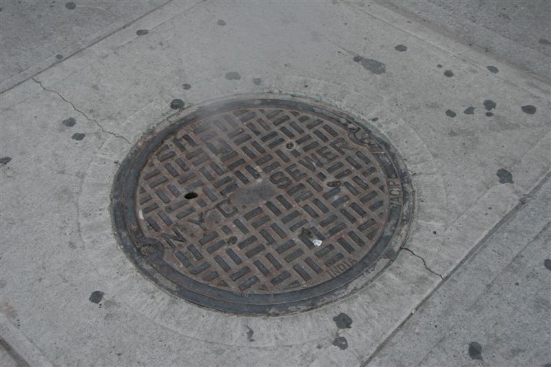 Steam billowing from sewer lid